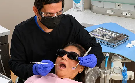 Dental professional wearing infection prevention mask and gloves