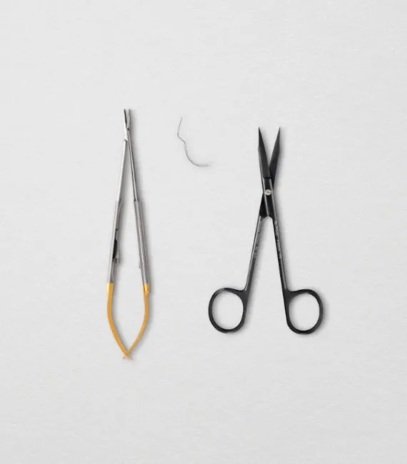 Hu-Friedy needle holder with suture and surgical scissors